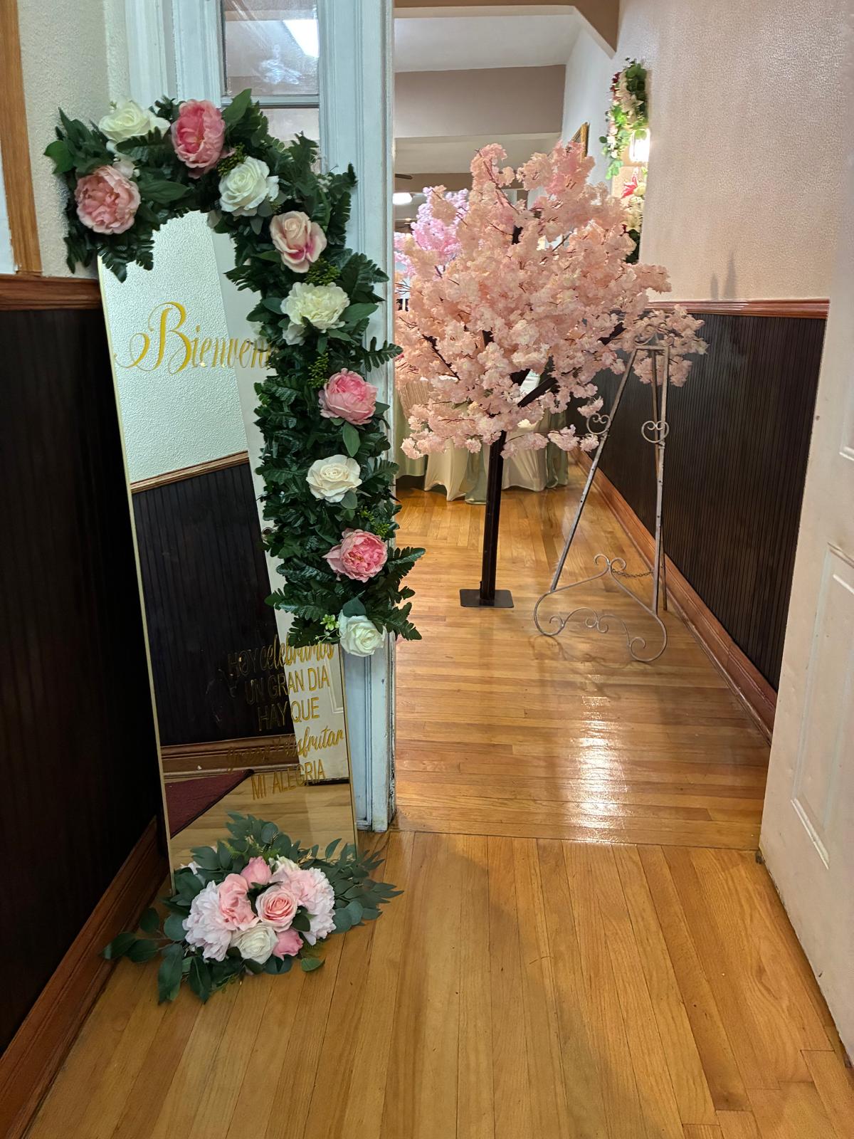 Pink floral welcome entrance with personalized sign