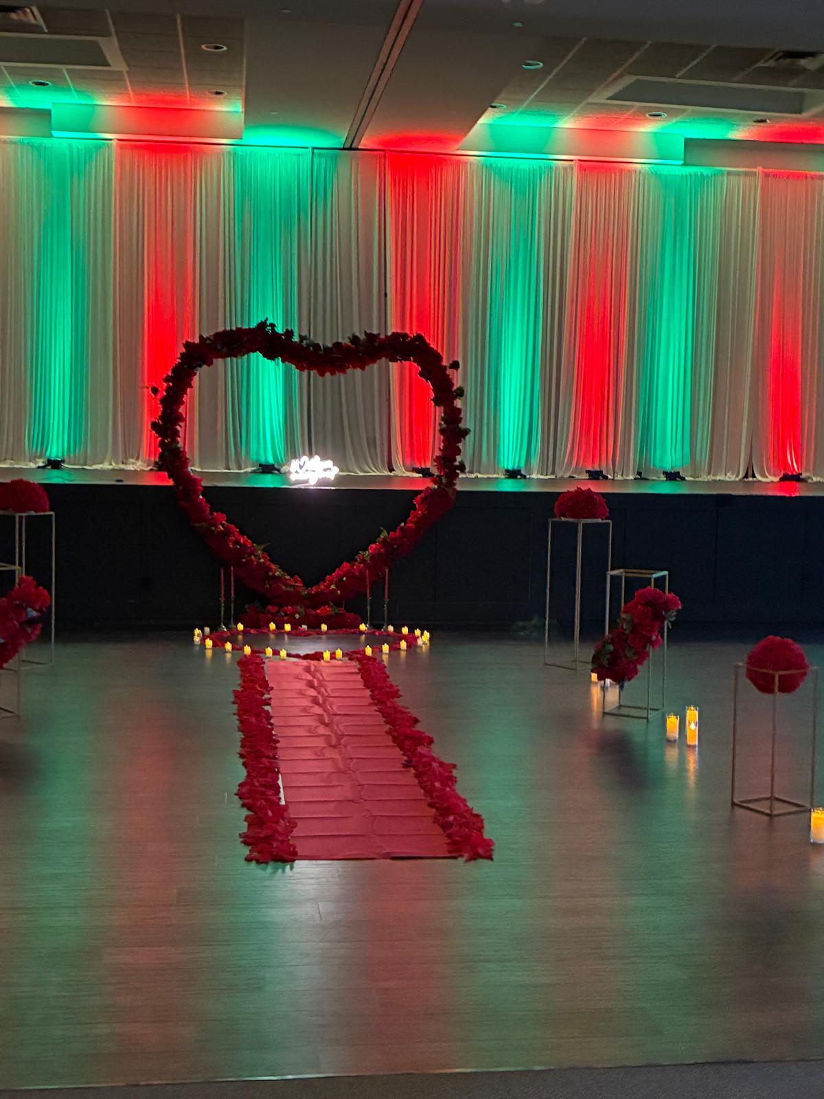 Wedding proposal setup with red carpet and rose heart